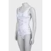 One-piece swimsuit with text print and tag