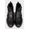 Leather boots decorated with a strap
