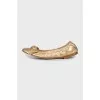 Golden ballet shoes decorated with a bow