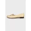 Golden moccasins decorated with a bow