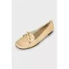Golden moccasins decorated with a bow