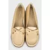 Golden moccasins decorated with a bow