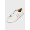 Leather sneakers with gold tongue