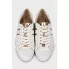 Leather sneakers with gold tongue
