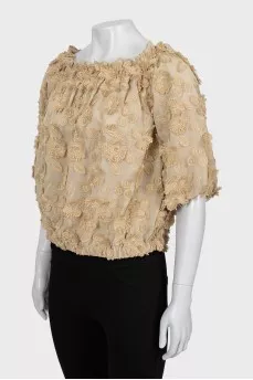 Blouse decorated with flowers and frills