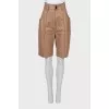 Leather Bermuda shorts with stitched arrows