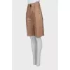 Leather Bermuda shorts with stitched arrows