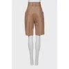 Leather Bermuda shorts with stitched arrows
