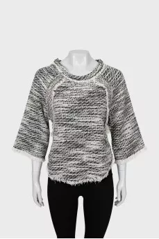 Knitted sweater decorated with fringe