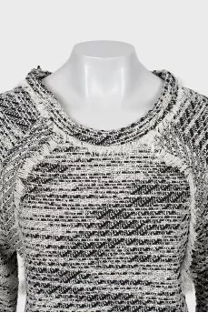 Knitted sweater decorated with fringe
