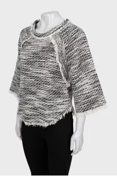 Knitted sweater decorated with fringe