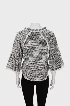 Knitted sweater decorated with fringe