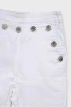 White jeans decorated with buttons
