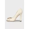 White leather shoes with golden logo