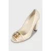 White leather shoes with golden logo