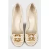 White leather shoes with golden logo