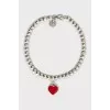 Silver bracelet with heart-shaped pendant