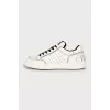 Black and white sneakers with brand logo