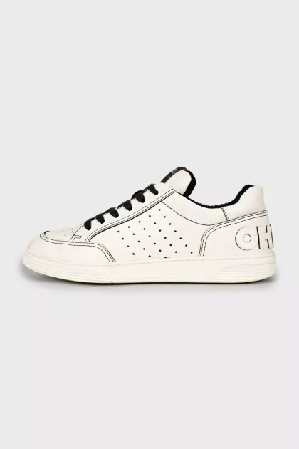 Black and white sneakers with brand logo