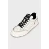 Black and white sneakers with brand logo