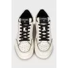 Black and white sneakers with brand logo