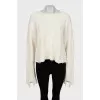 Knitted sweater with ripped effect
