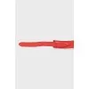 Red belt with gold buckle