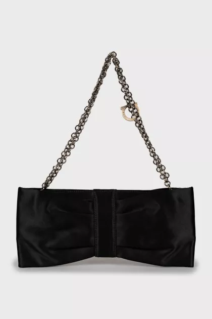 Textile clutch in the form of a bow