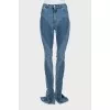 Jeans with raised seams and slits at the bottom