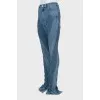 Jeans with raised seams and slits at the bottom