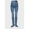 Jeans with raised seams and slits at the bottom