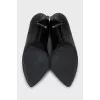 Black leather shoes with perforations