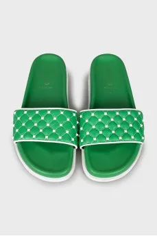 Green slippers decorated with spikes