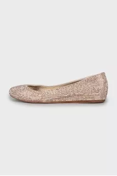 Golden ballet shoes decorated with rhinestones