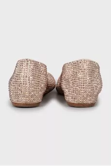 Golden ballet shoes decorated with rhinestones