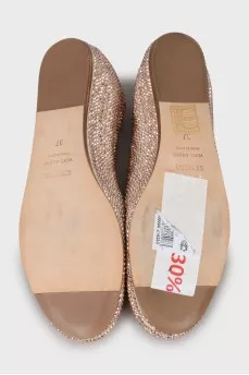 Golden ballet shoes decorated with rhinestones