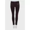 Purple jeans decorated with zippers