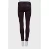 Purple jeans decorated with zippers