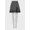 Skirt decorated with lace with a slit
