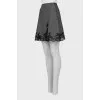 Skirt decorated with lace with a slit