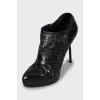 Black leather ankle boots with stiletto heels