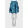 Pleated skirt decorated with embroidery