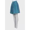 Pleated skirt decorated with embroidery