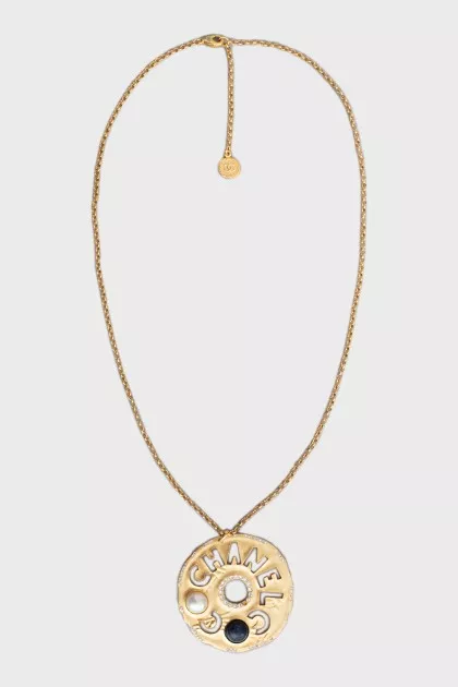 Gold pendant with brand logo