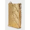 Gold-tone phone case on a chain