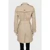 Beige trench coat with gold buttons