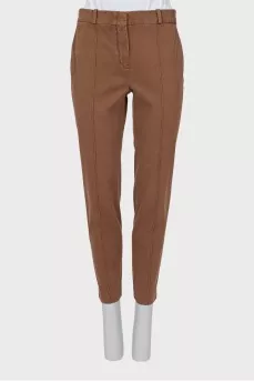 Brown trousers with sharpened creases