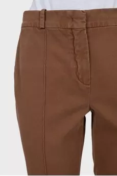 Brown trousers with sharpened creases