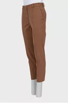 Brown trousers with sharpened creases