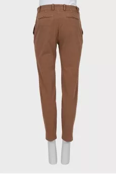 Brown trousers with sharpened creases